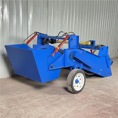 農(nóng)田開(kāi)荒耕地?fù)焓瘷C(jī)器 拖拉機(jī)帶的有石頭的收集箱